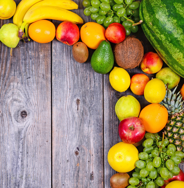 Huge group of fresh colorful fruit on wooden background - Health - Foto, afbeelding