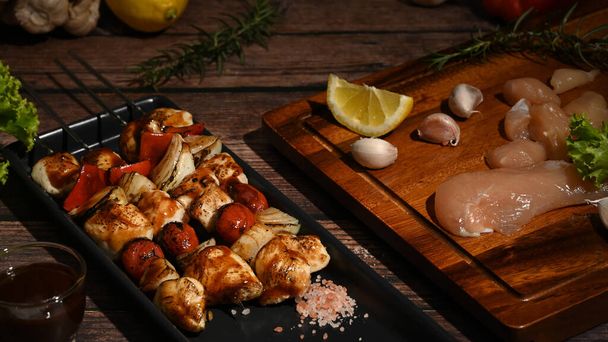 Tasty grilled chicken skewers with ingredients on wooden background. Copy space for your text - Foto, Imagen