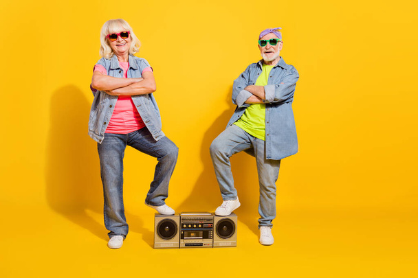 Photo of sweet funny girlfriend boyfriend dressed denim outfit listening boom box arms folded isolated yellow color background - Φωτογραφία, εικόνα