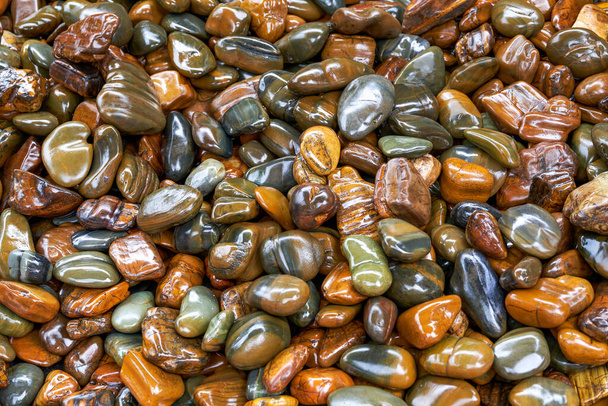 Close-up of shiny pile of pebbles - 写真・画像