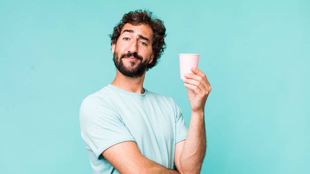 young adult hispanic crazy man with a paper cup coffee - Foto, imagen