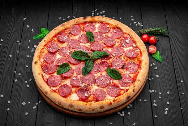 Italian pizza pepperoni with salami. Delicious traditional Italian food - Photo, Image