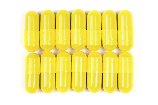 Pharmaceutical pills, medicine for people's health to heal diseases. Yellow tablets on white background. High resolution photo. Full depth of field. - Фото, зображення
