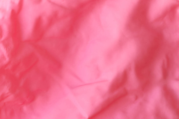 Texture of red crumpled rubber balloon. Crumpled rubber of a children's balloon. - Foto, Imagen