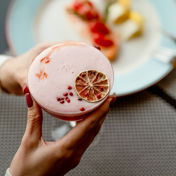 elegant cocktail with foam decorated with red pepper and dry citrus - Foto, Imagen
