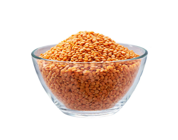 organic red lentils in a clear glass bowl isolated on white background. - Photo, Image