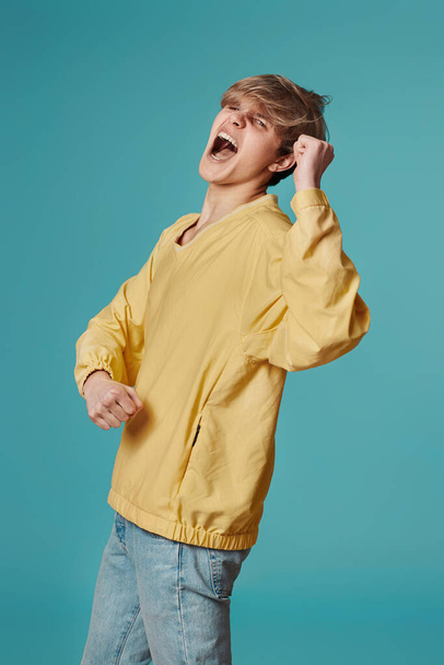 young man in casual yellow clothes dancing - Fotó, kép
