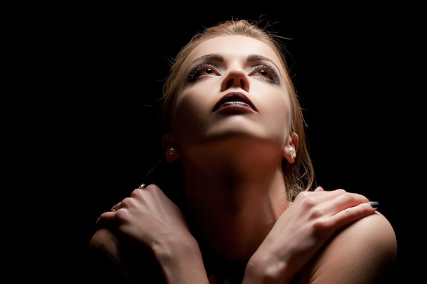 Young sensual woman in ray of light - Foto, Bild