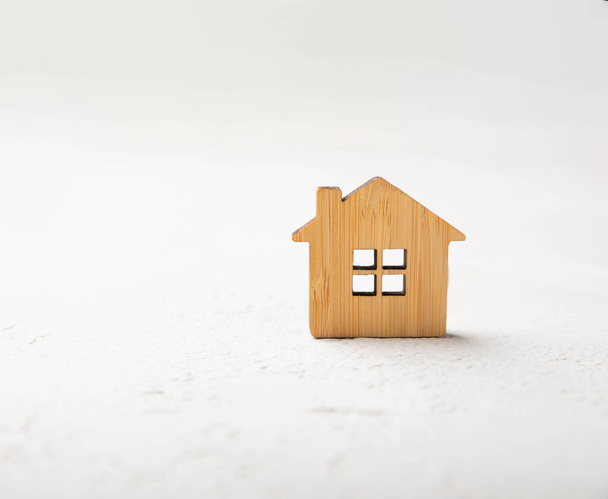 Wooden house model on a gray marble background. real estate investment concept.money savings planning for buying a house. Real estate concepts. Mortgage and real estate investment, savings for home. - Photo, Image