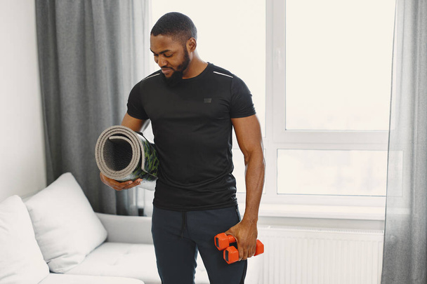 Handsome Afro American sportsman working out at home - Foto, Imagem