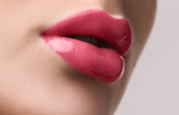 Woman with beautiful perfect lips after permanent makeup procedure on light background, closeup - Foto, imagen