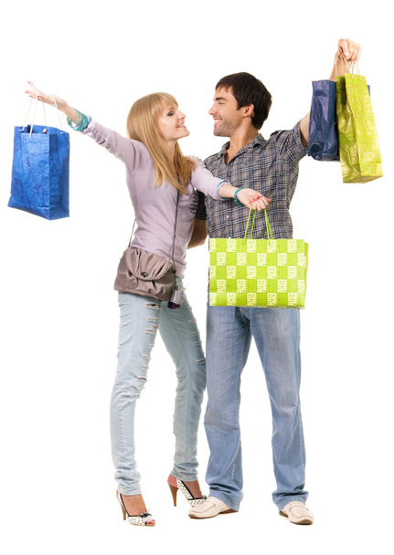 Belo jovem casal com sacos de compras
 - Foto, Imagem
