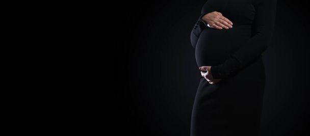 Panoramic shot of pregnant woman touching her belly with copy space - Фото, изображение