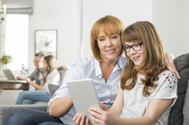 mother and daughter using digital tablet - 写真・画像