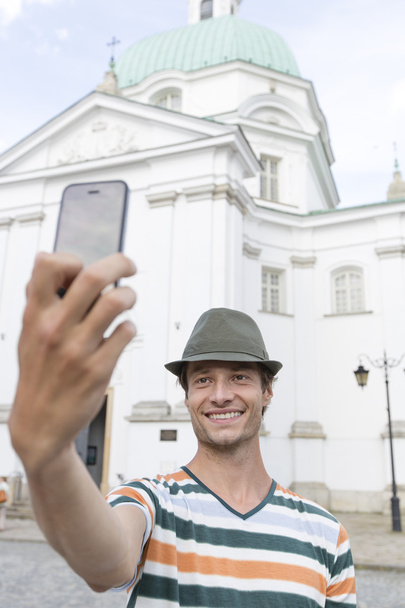 man taking self portrait outside St. Casimir Church - Φωτογραφία, εικόνα