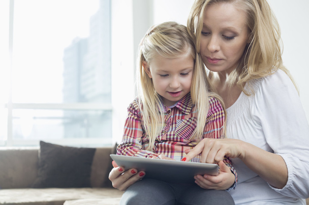 Woman with daughter using digital tablet - Photo, image