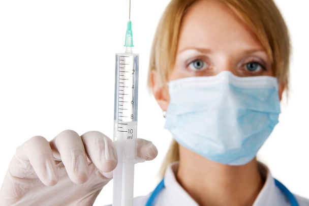 Nurse in a mask with syringe - Фото, изображение