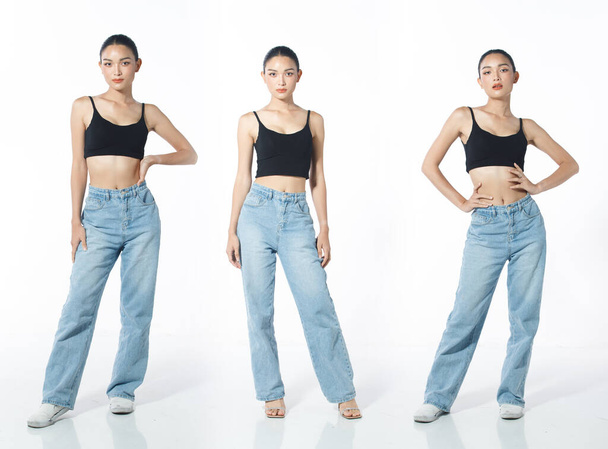 Full length Figure snap of 20s Asian Woman black hair vast jeans pant and sneaker. Casual beautiful Female stands poses show body skin over white Background isolated - Φωτογραφία, εικόνα