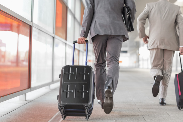 businessmen with luggage running - 写真・画像