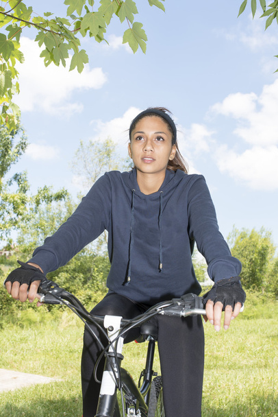 Portrait of woman riding a bike, outdoor. - Photo, Image