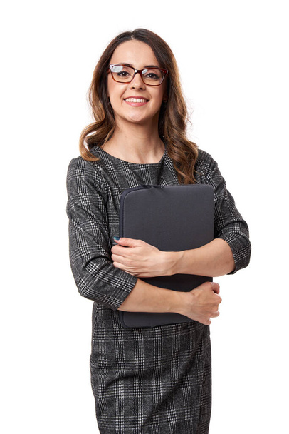 Happy succesfull young businesswoman holding her laptop, isolated on white background - Fotó, kép