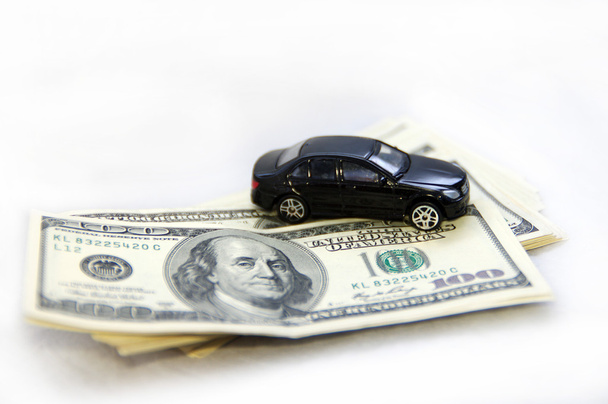 Pack of hundred-dollar notes and children's toy car - Photo, image
