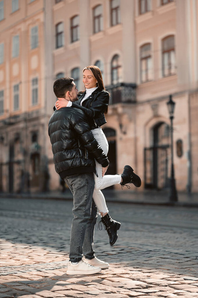Lovely young couple having fun together on city street. Romantic date - Φωτογραφία, εικόνα