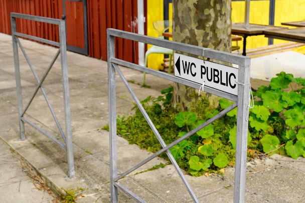 wc public arrow grey fence street text means Toilets public restroom sign panel access - Photo, Image