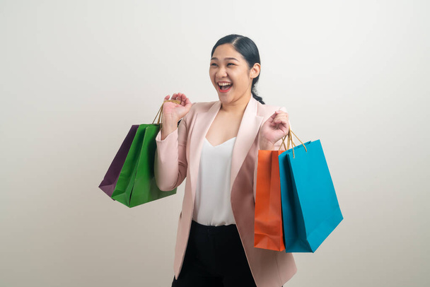 Asian woman holding shopping bag on hand with white background - Fotó, kép