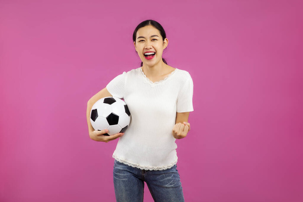 Asian Young Girl Football fan over isolated pink background holding a soccer ball, sport an people concepts - Фото, зображення