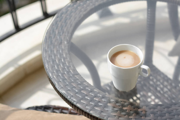 Ceramic cup of aromatic coffee on glass table outdoors. Good morning - Fotó, kép