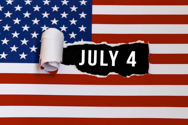 July 4 message on American flag torn ripped opening. Independence Day. Directly above shot Hollyday concept.  - Photo, Image