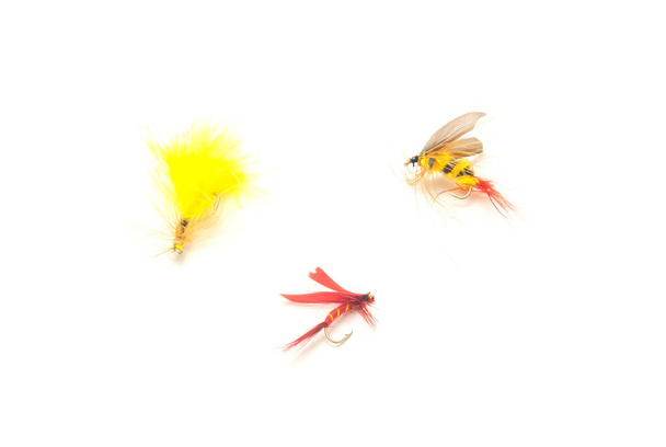 Three fly fishing lures in different files, colors and hook sizes isolated on white background. Assortment of dry, wet hand-tied light weight flies with sharp carbon steel hooks - Valokuva, kuva