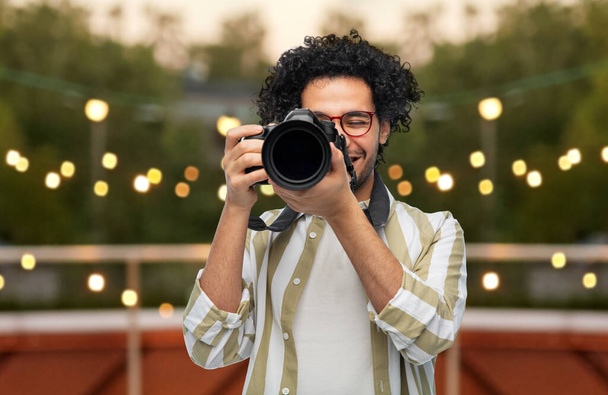 man or photographer with digital camera at party - Фото, зображення