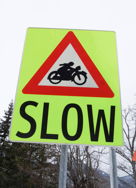 driving slow sign in road traffic, speed calming and motorcycles - Фото, изображение