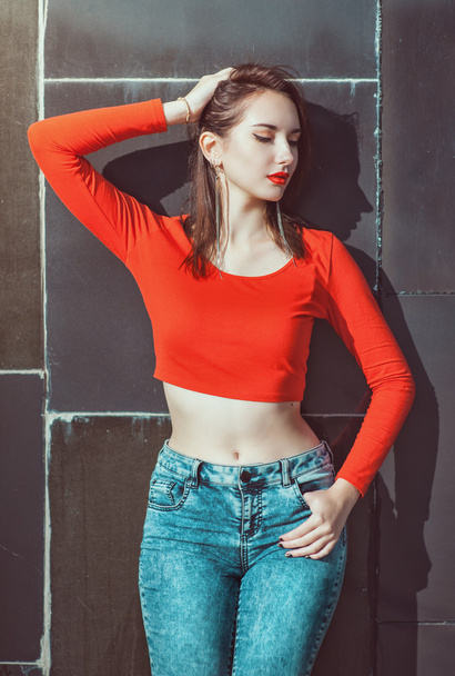 Young beautiful girl in red blouse enjoy sunlight - Фото, изображение
