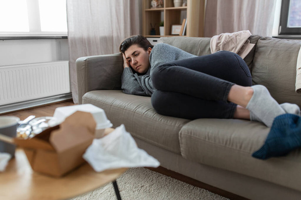depressed woman lying on sofa at home - Photo, image