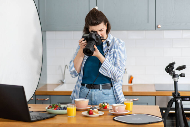food photographer with camera working in kitchen - Fotoğraf, Görsel