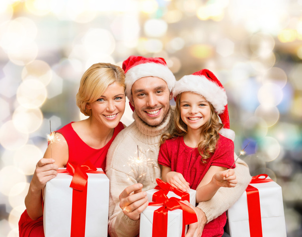 happy family in santa helper hats with gift boxes - Fotó, kép