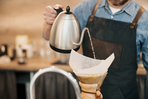 Close up of man barista making filter coffee in cafeteria - Fotografie, Obrázek