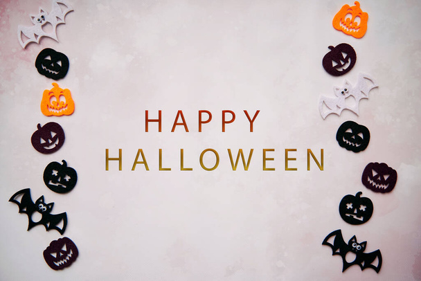 Happy Halloween lettering with Halloween decorations with bats, cute pumpkins. Minimalistic festive concept. High quality photo. - Photo, Image