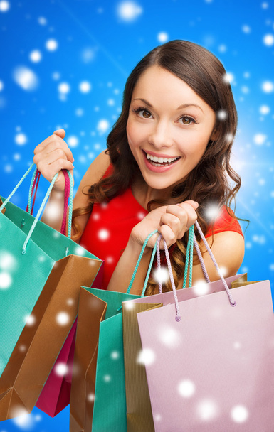 smiling woman with colorful shopping bags - Foto, Bild