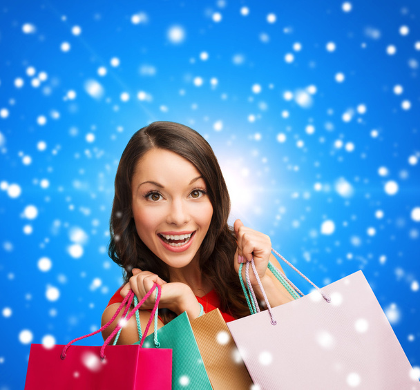 smiling woman with colorful shopping bags - Photo, image