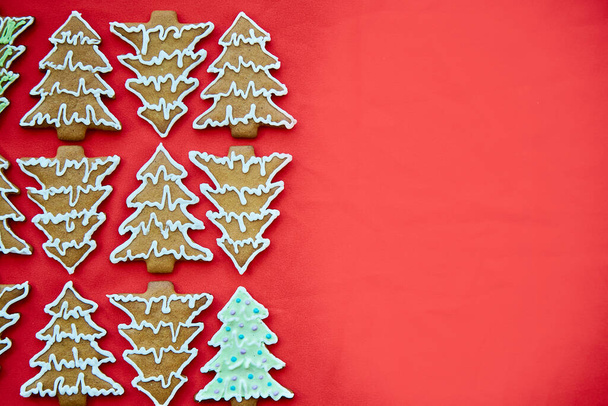 Christmas homemade gingerbread christmas tree cookies, copy space. One different. Handmade baking background. Festive card with aesthetic Christmas atmosphere. Merry Christmas and home coziness - Photo, Image