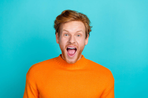 Photo of attractive impressed guy dressed orange sweater open mouth isolated turquoise color background - Foto, imagen
