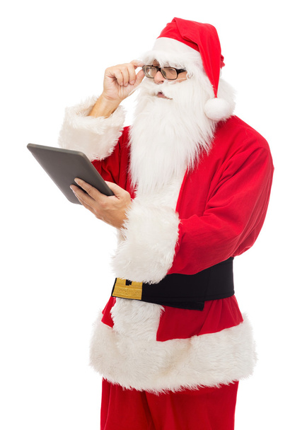 man in costume of santa claus with tablet pc - Foto, imagen