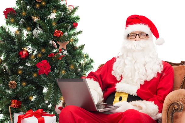 man in costume of santa claus with laptop - Foto, Imagen