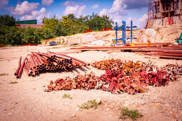 View on heap of disassembled steel scaffolding joint on construction site. - Photo, Image