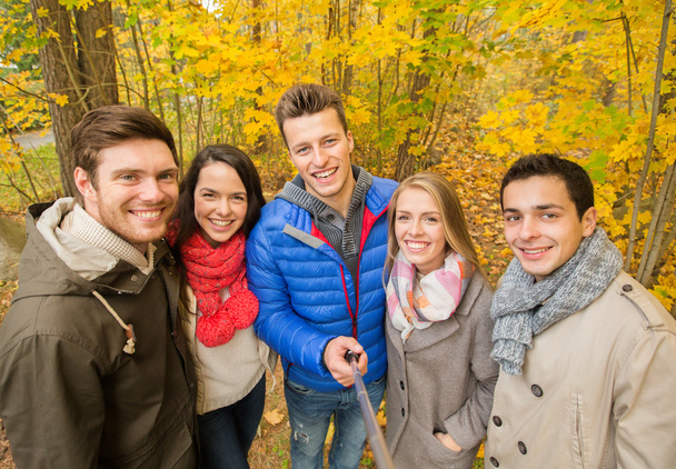 smiling friends taking selfie in autumn park - Photo, image