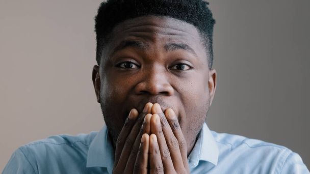 Shocked happy african american young boyfriend business man surprised look at camera rejoice good news amazed guy joyful male winner show wow reaction feel amazing triumph excitement cover face hands - Photo, Image